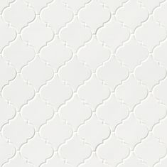 a white tile with an intricate pattern on it