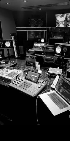 there are many electronic equipment on the table in this room and one is black and white