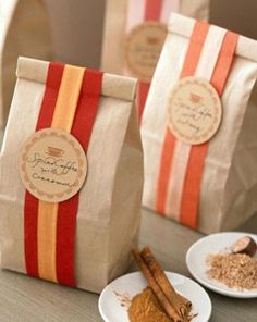 three bags of spices sitting on top of a table next to two plates with cinnamons