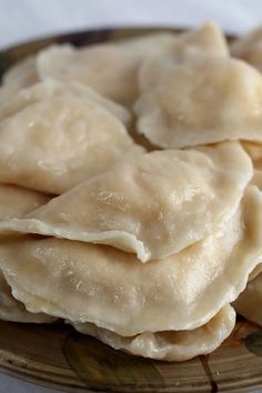 some dumplings are sitting on a brown plate