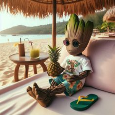 a stuffed toy sitting on top of a bed next to a pineapple and sunglasses