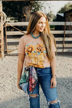 Saddle up in style with our Boots & Roses Tee! Made from soft 100% cotton fabric, this western tshirt features a playful cowboy boots and roses graphic, perfect for any cowgirl. The coral mineral wash adds a unique touch to this short sleeve tee. Haylee is wearing size small paired with The Carter Jeans, the Coyote Knox Sandals and Vintage Feedsack Wild Rag Western Tshirt, Roses Graphic, The Carter, Wild Rag, The Coral, Fall Clothes, Curvy Dress, Heritage Collection, Bottoms Pants