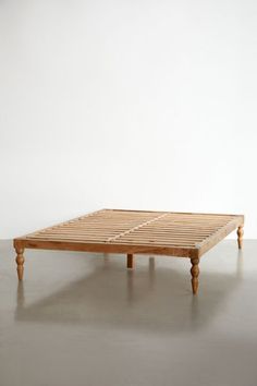 a wooden bed frame sitting on top of a floor