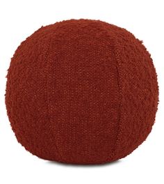 an orange knitted round pillow on a white background with the word's name written in