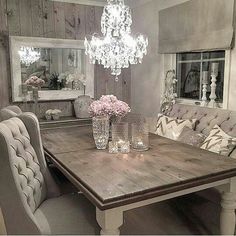 a dining room table with chairs and a chandelier