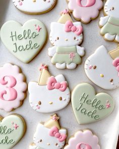 hello kitty cookies are arranged in the shape of hearts and unicorns on a tray