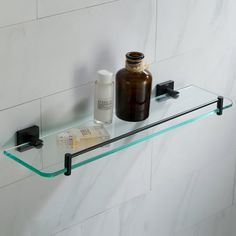 a glass shelf with a bottle and medicine on it