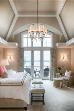 a bedroom with a large bed sitting under a chandelier