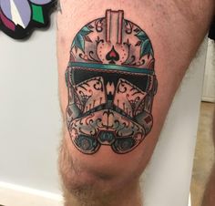 a tattoo on the leg of a man with a helmet