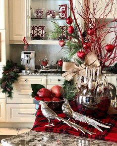 a kitchen decorated for christmas with silverware and ornaments