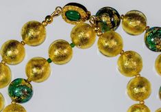 Gold and Green and 24K Gold Leaf Murano Necklace Gold Emerald Necklace With Round Beads For Festive Occasions, Gold Single Strand Murano Glass Necklace, Gold Murano Glass Single Strand Necklace, Round Murano Glass Gold Jewelry, Gold Glass Beaded Necklace With Polished Beads, Gold Necklace With Large Glass Beads, Gold Emerald Necklace With Round Beads, Gold Emerald Necklace With Single Strand, Gold Emerald Necklace With Round Beads Single Strand