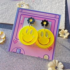 Laser cut acrylic stud earrings featuring a double layer smiley face with a neon yellow top and unattached white bottom for a fun effect with a black painted stud earring, perfect for all your rad y2k inspired outfits. Hardware for both the stud post as well as the jump rings is stainless steel and holds up much better to discoloring than cheaper brass versions! Trendy Yellow Plastic Earrings, Trendy Neon Yellow Earrings For Gifts, Neon Yellow Tops, Y2k Inspired Outfit, Charm Holder, Spring Earrings, Acrylic Jewellery, Laser Cut Acrylic, Homemade Jewelry