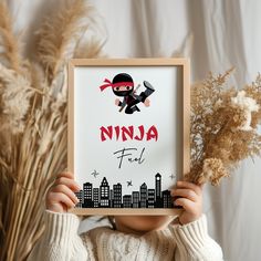 a young child holding up a sign with the word ninja fall in front of them