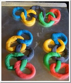 four rings made out of dough sitting on top of a pan