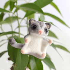 a small stuffed animal hanging from a plant