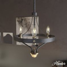 a chandelier with three lights hanging from it