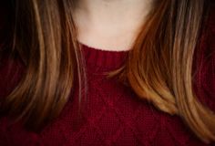 a close up of a person wearing a red sweater