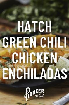 the words hatch green chili chicken enchiladas on a black plate with greens