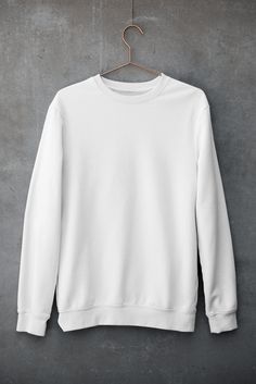 a white sweatshirt hanging on a hanger