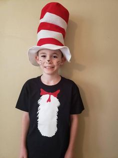 a young boy wearing a cat in the hat costume