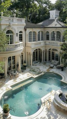 a large house with a pool in the middle