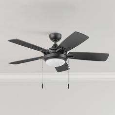 a black ceiling fan with two lights on each side and a white light hanging from the ceiling