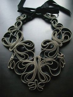 a black and silver necklace on a table