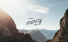 the words still for merrcy are in front of some mountain peaks and trees