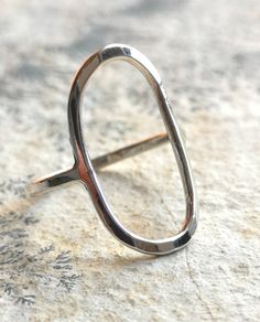 The design of this simple, modern ring is both extremely comfortable and large enough to make a statement. Perfect for everyday wear! This ring would make a great gift, either for someone special, or as a treat to yourself. Measurements: The oval is approximately 1x2cm in diameter, the band is made to order in any size Band: 1.5mm Metal Finish: Hammered for hardness and texture and brushed for a shiny, silky finish Your new ring will arrive ready for gifting, packaged in a sturdy paper kraft box Minimalist Oval Stackable Rings For Everyday, Modern Oval Promise Ring, Modern Stackable Rings With Open Circle For Everyday, Modern Everyday Stackable Rings With Open Circle, Modern Stackable Open Circle Rings For Everyday, Minimalist Oval Everyday Rings, Modern Oval Rings With Simple Design, Everyday Simple Oval Rings, Modern Oval Jewelry With Simple Design