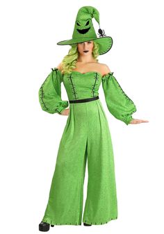 a woman in a green costume is wearing a hat and holding her hands out to the side