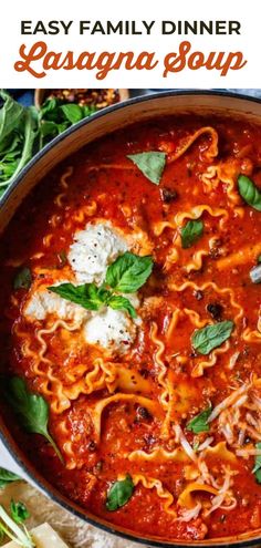 an easy family dinner with lasagna soup in a skillet, garnished with parmesan cheese and basil