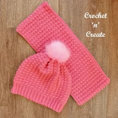 a crochet hat and scarf with a pink pom - pom