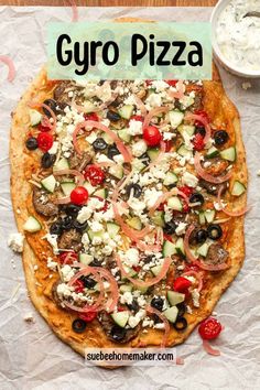 a pizza sitting on top of a table covered in toppings