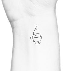 a black and white photo of a coffee cup tattoo on the left side of someone's arm