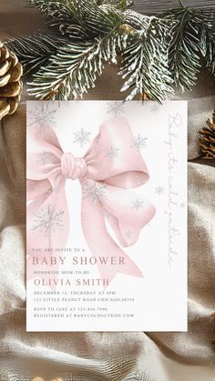 a baby shower with pink bows and pine cones