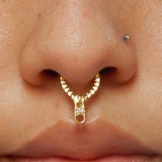 a woman's nose with a gold nose ring