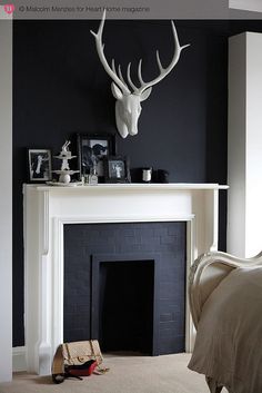 a fireplace with a deer head above it