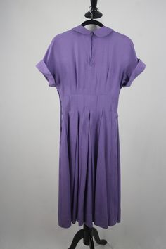 "1950s hand made dress. Purple rayon, plain weave fabric. The weight of the fabric would make a great swing dress. Peter Pan collar and cuffed cap sleeves. Wide, 3\" waist. Waist, collar, and cuffs have stiffening in them. Full skirt is box pleated and has reverse, decorative seaming. (see next to last photo although the color is off in this photo) 3.5\" hem. Fastens in the back with a short metal zipper and another one in the side. Freshly laundered. Excellent condition. There is one small dark 1950s Short Sleeve Dress For Vintage Fashion, 1950s Short Sleeve Vintage Fashion Dress, 1950s Style Vintage Fashion Dress With Short Sleeves, 1950s Style Short Sleeve Vintage Dress, Solid Color Vintage Cotton Dress, 1950s Style Lined Short Sleeve Dresses, 1950s Style Short Sleeve Lined Dress, Vintage Cap Sleeve Dresses, Classic Short Sleeve Lined Vintage Dress