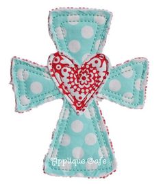 an applique cross with a heart on it