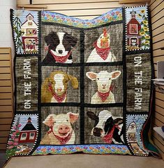 a quilt is hanging on the wall with pictures of dogs and farm animals in it