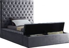 an upholstered bed with storage underneath the headboard and foot board is shown