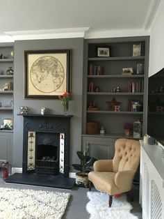 a living room filled with furniture and a fire place in front of a tv mounted on a wall