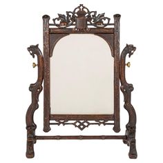 an ornate wooden mirror with carvings on the sides and a white back ground, isolated against a white background