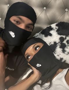 two people wearing masks on top of each other