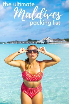 a woman standing in the water wearing a red and white polka dot bathing suit with text overlay that reads, the ultimate maldives packing list