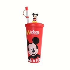 a mickey mouse cup with a toothbrush in it