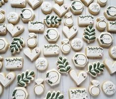 decorated cookies with wedding date and names on them are laid out for the guests to eat