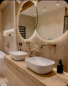 a bathroom with two sinks and a large mirror on the wall above it's counter