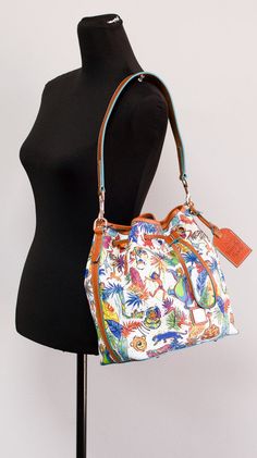 Style: Dooney & Bourke Disney's The Jungle Book Bucket Drawstring Bag Material: Printed Coated Cotton Features: Inner Zip and Slip Pockets, Adjustable/Detachable Crossbody Strap, Detachable Top Handle Shoulder Strap, Canvas Lined, Bottom Studs Measures: 10" W x 10" H x 7" D MSRP: $299 Book Bucket, Dooney And Bourke Disney, The Jungle Book, Crossbody Strap, Dooney Bourke, Drawstring Bag, Cross Body Handbags, Tech Accessories, Amazing Jewelry