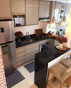 a modern kitchen with stainless steel appliances and black counter tops